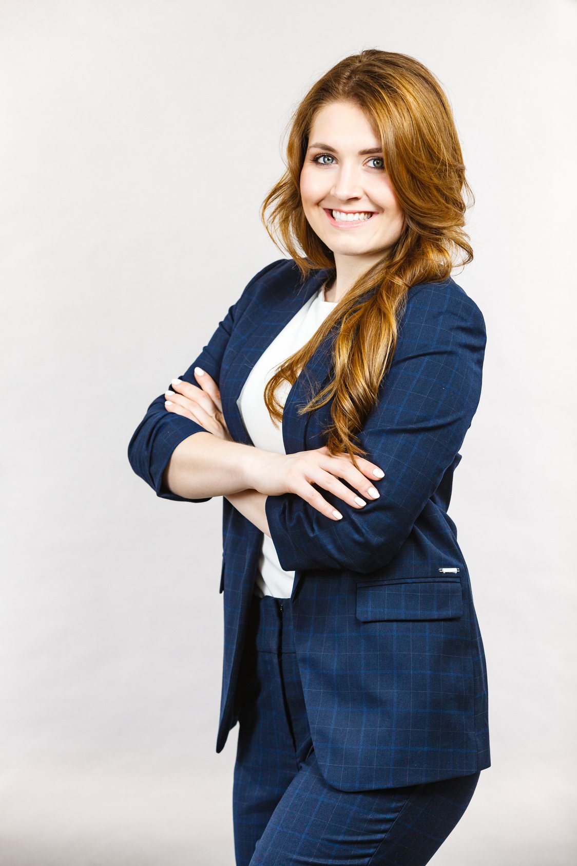 Business woman in suit folded arms