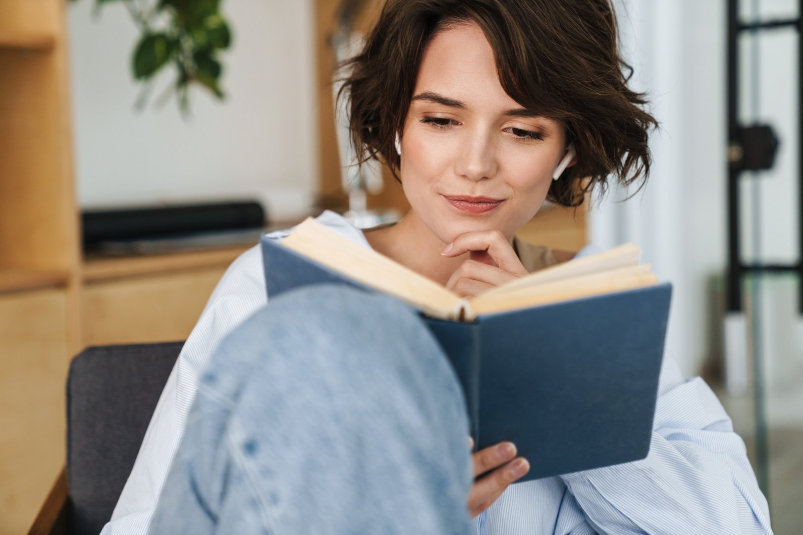 Smiling Young Woman Entrepreneur Reading Book